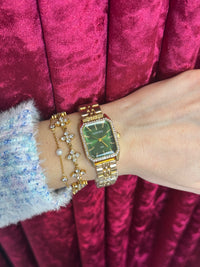 Gold watch with green dial
